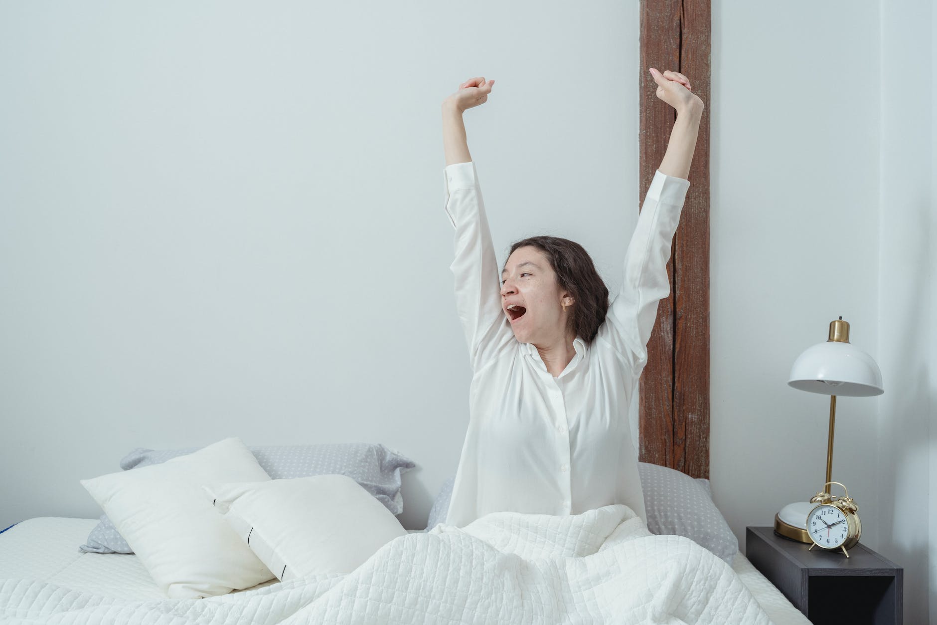 young woman awakening in bed in morning